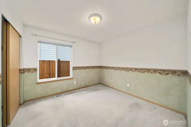 Another secondary bedroom with nice sized closet and large window for natural light.