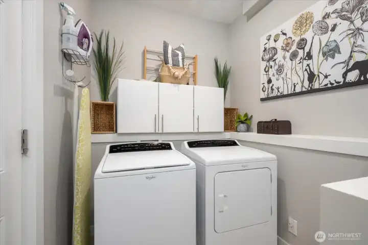 A well appointed laundry room is tucked onto the main level