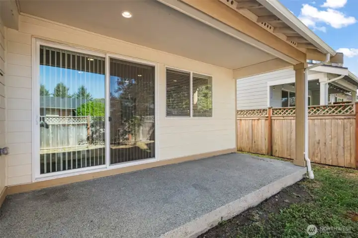 The large covered porch is great for outdoor seating and storing your BBQ grill