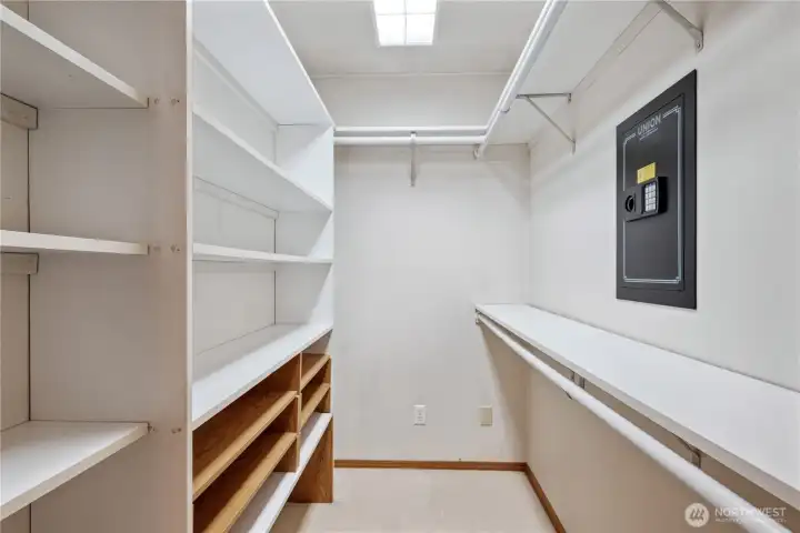 Primary walk in closet with wall safe