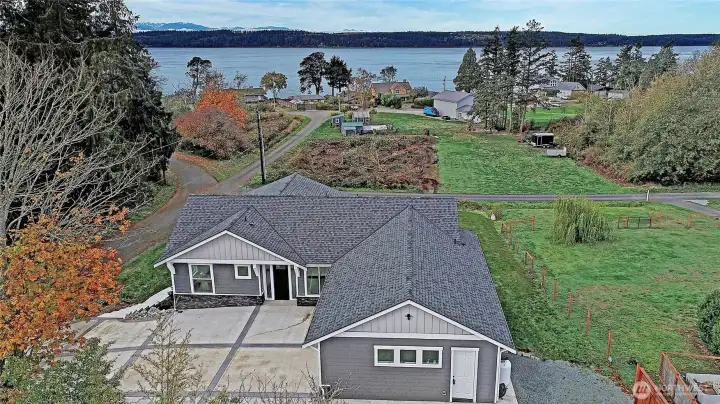 West-facing beauty with sweeping water and mountain views, modern island living at its finest.