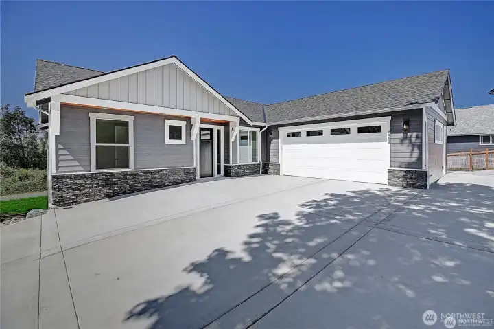 Large two car garage with ample parking and extra space next to the garage.