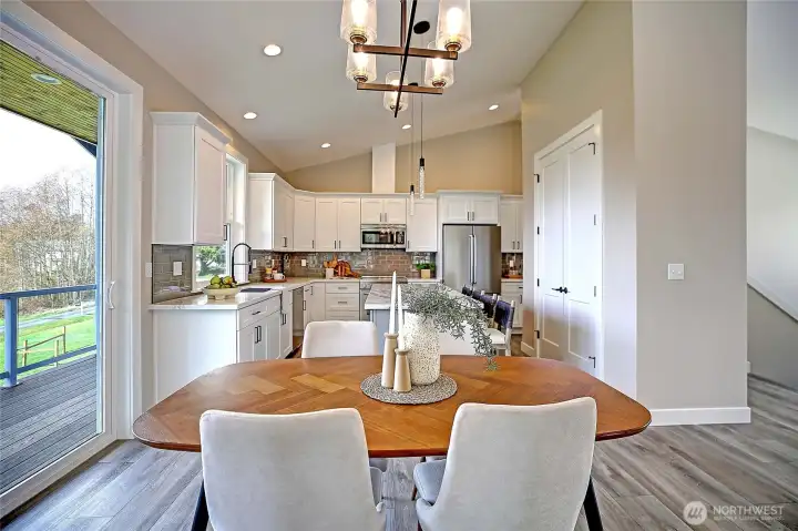 Open concept living with large glass door to covered deck.