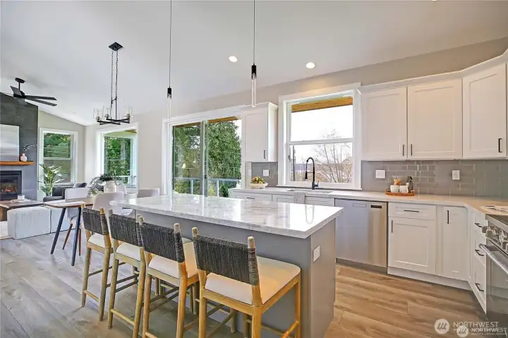 Bright open-concept kitchen with large island, quartz counters, and seamless flow to the living area