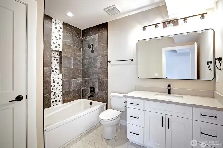 Guest bathroom with custom tiled shower.