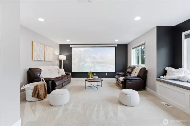 Impressive media room with projector and screen plus motorized blinds for awesome movie nights!