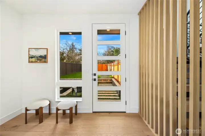 Modern entry featuring clean architectural lines and built-in wood slat detailing.
