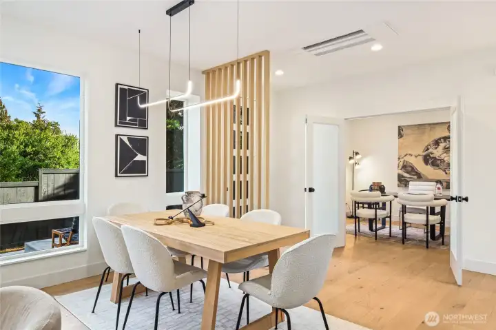 Great room anchored by a sleek linear fireplace and framed by floor-to-ceiling windows.