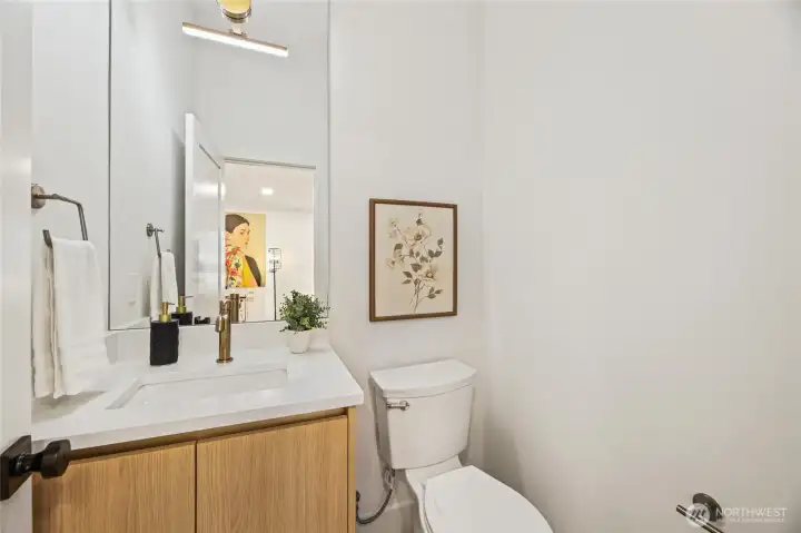 half-bath featuring modern floating vanity and designer fixtures.