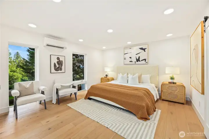 Bright secondary bedroom featuring high ceilings and minimalist design.