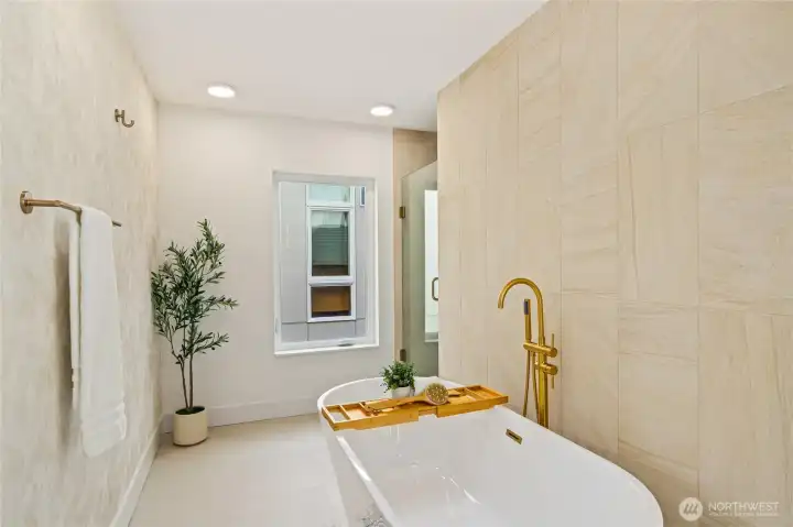 Luxury bath detail featuring gold-toned hardware and bespoke stone tile.