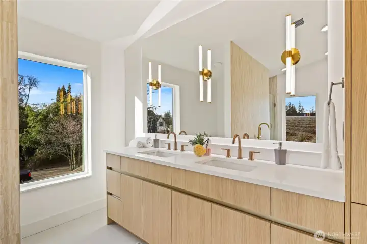 Custom dual-sink vanity with designer lighting and ample storage.