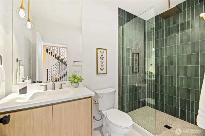 Contemporary guest bathroom featuring sleek hardware and a stylish walk-in shower.