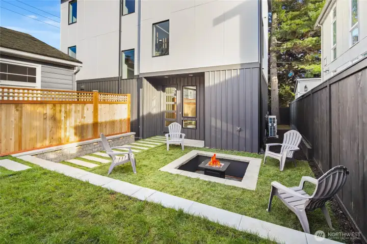 Professionally landscaped yard with a custom patio area, perfect for alfresco dining.