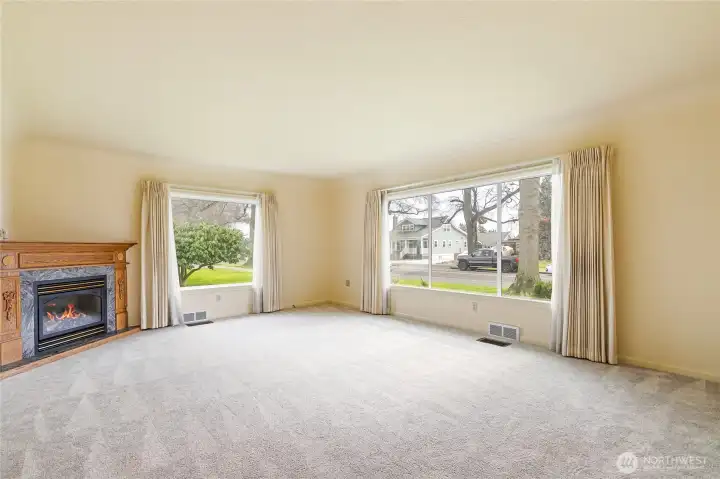 The large picture windows allow a lot of light. The gas fireplace is warm and inviting.