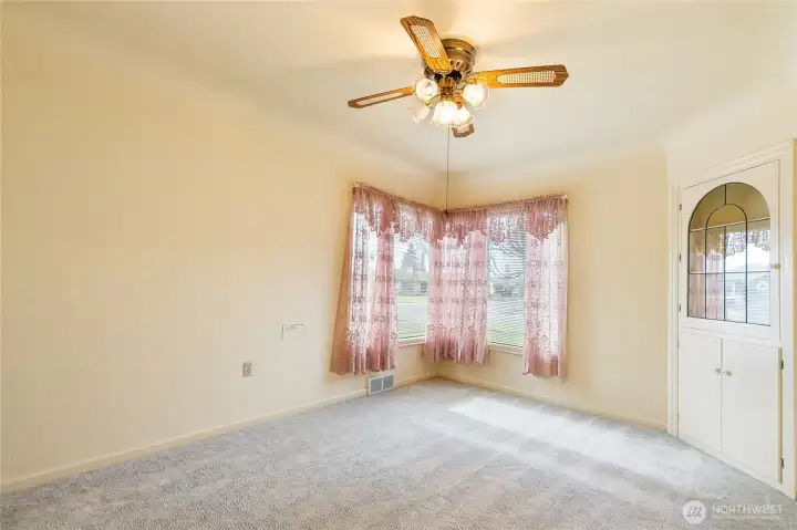 The corner windows give you natural light and the built-in corner hutch is a great feature of this mid-century home, as is the mail drop box on the wall.
