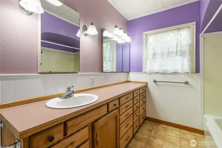 The main floor bath has an abundance of storage space.