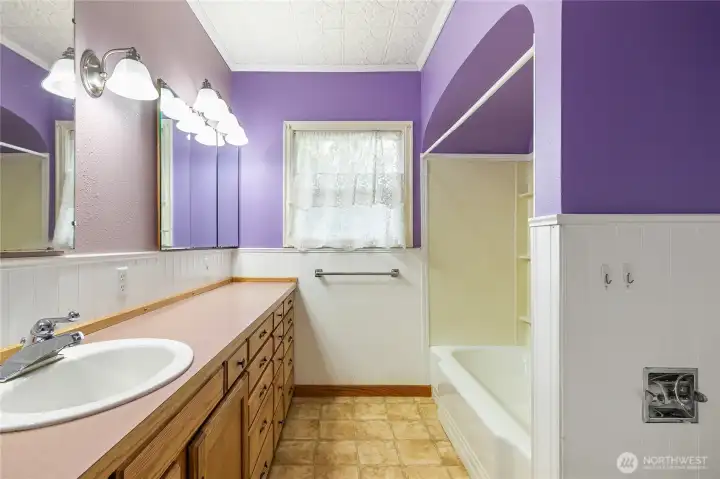 A full tub with a shower. Note the ceiling tiles...