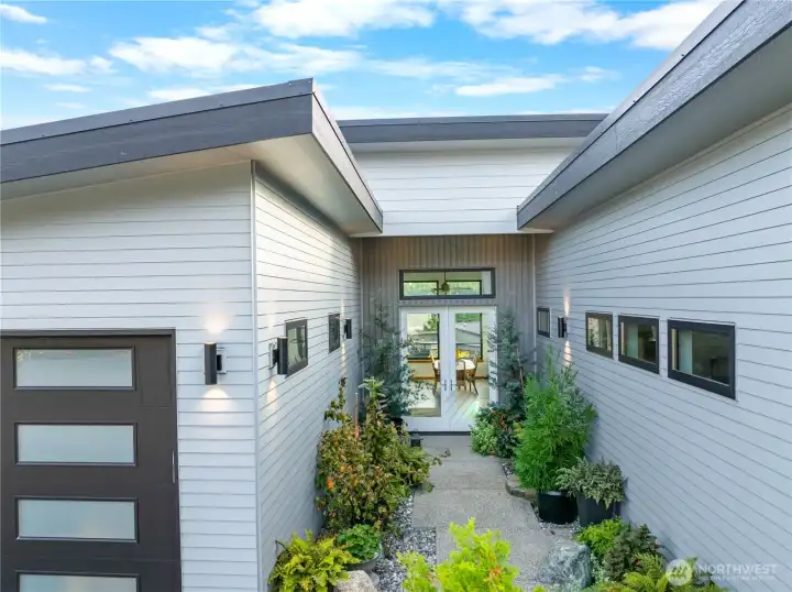 Courtyard entry leads to double glass front doors. All main level with no steps.