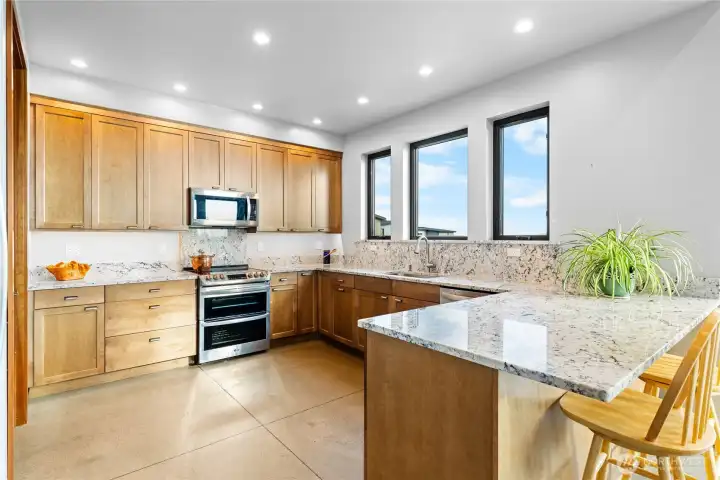 Peninsula style kitchen has an abundance of counter area.