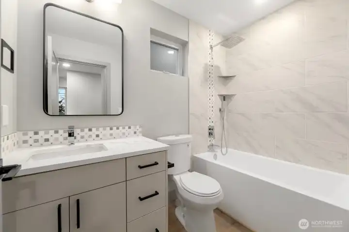 Upper level spa-like bathroom with custom vanity, high-end finishes and Italian tile floors and shower.