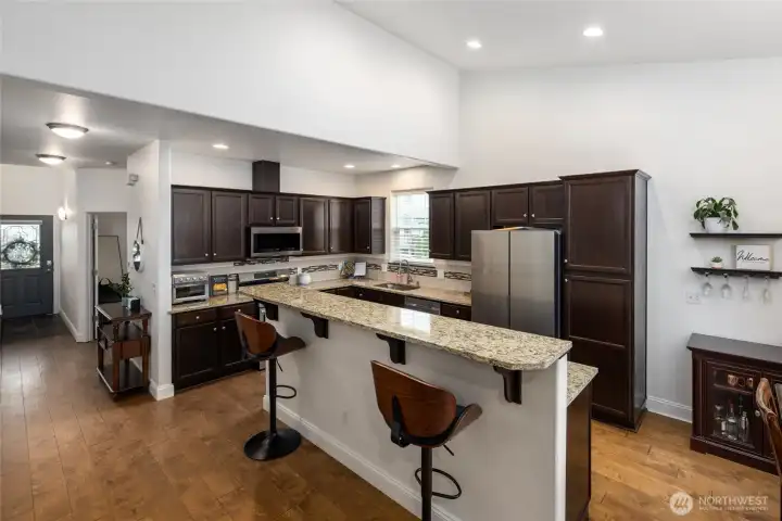 Open concept kitchwn with lots of cabinets and an island.