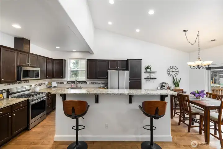 Storage galore in this kitchen, with stainless steel appliances.