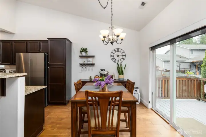 Dining area opens to deck and kitchen.