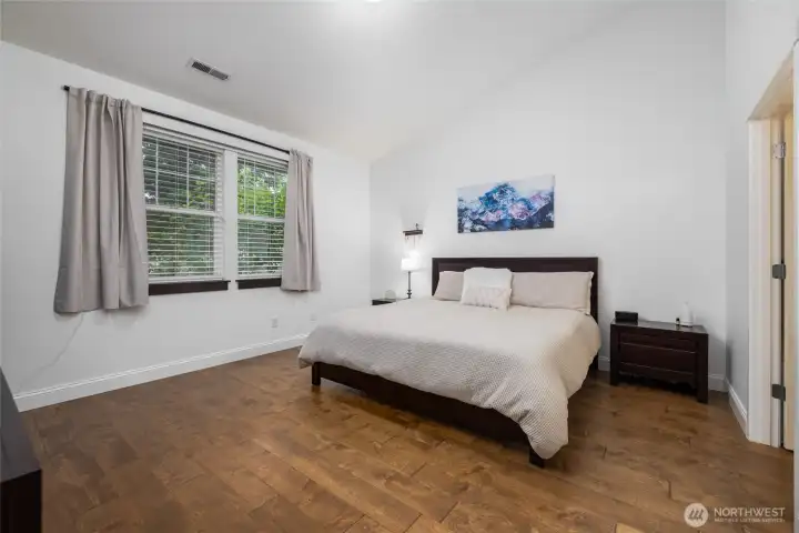 Main level Primary bedroom, spacious with engineered hardwood floors.