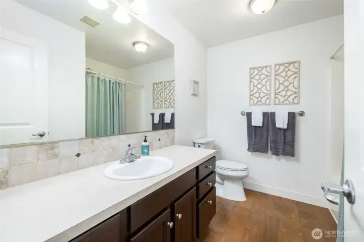 Upstairs full bathroom, with large vanity for extra counterspace and storage.
