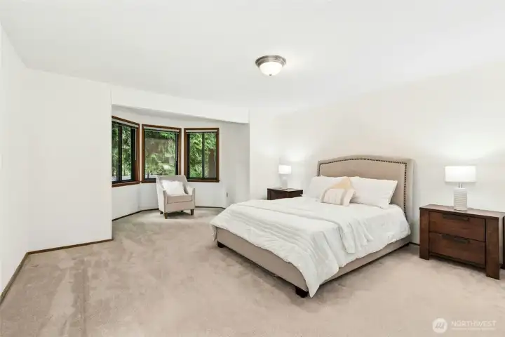 The spacious primary suite has a cozy sitting area. The spacious primary suite has a cozy sitting area.