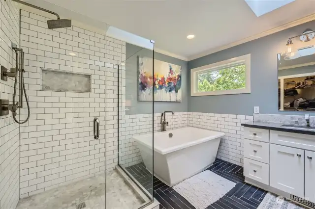 The Primary Suite's 5-piece bath was remodeled in 2018 with designer finishes, featuring a walk-in shower, stand-alone tub and stunning tilework on the flooring and surrounds.