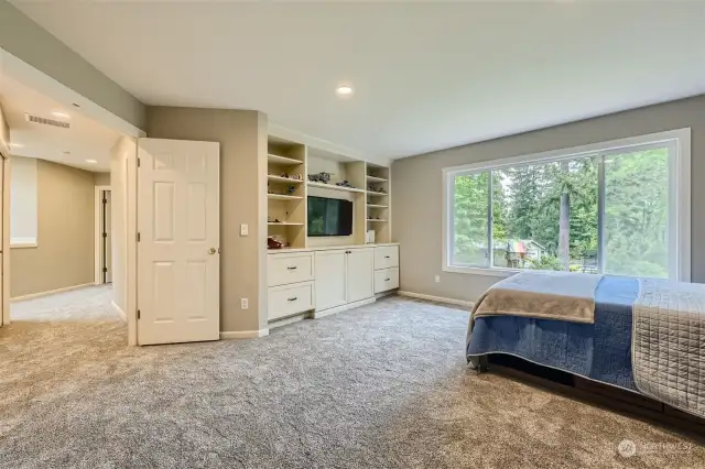 Through French doors, enter the Bonus room on the upper level, featuring new built-in bookshelves and cabinetry and overlooking the lush, treed backyard.  New carpet and fresh paint.