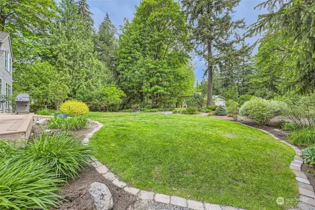 This shy acres of grounds will be a delight for gardeners, children and adults alike.  2 apple trees, plum tree,  many highly-productive blueberries and lilies & roses galore.  Plus raised gardens to watch your vegetables grow. In-ground sprinkler system, with extra zones that may be added.