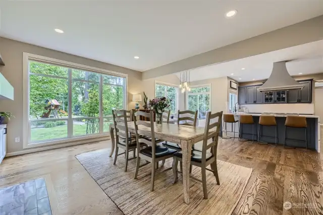 Additional hardwood floors were installed in 2021, so that they continued throughout the main floor. Huge floor-to-ceiling picture windows view the level and fully-fenced backyard.