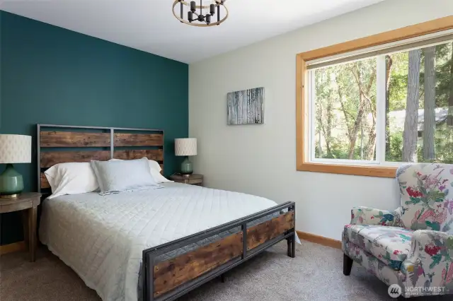 Main floor bedroom featuring queen bed and large window. (Bedroom #3)