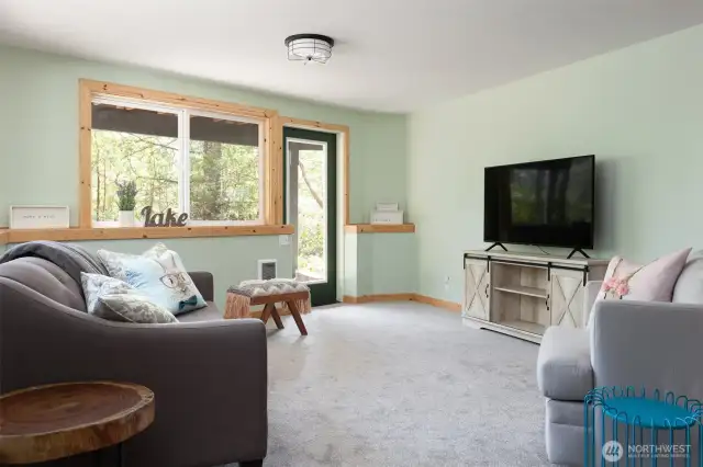 Downstairs family/entertainment room with TV and wet bar with a mini fridge and microwave. Hot tub is right outside this room.