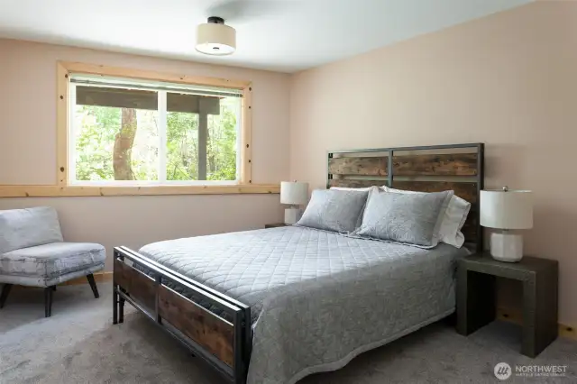 Downstairs bedroom featuring queen bed and large window. (Bedroom #5)