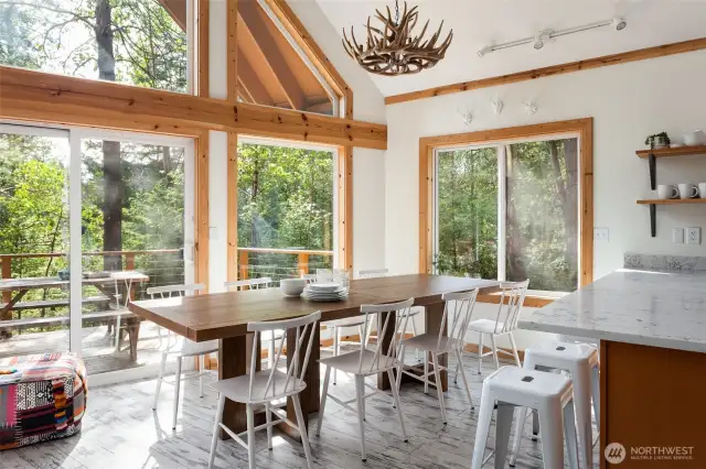 Dining room featuring gorgeous natural light and views of the surrounding trees.