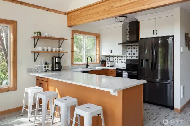 Newer kitchen and appliances featuring induction range.