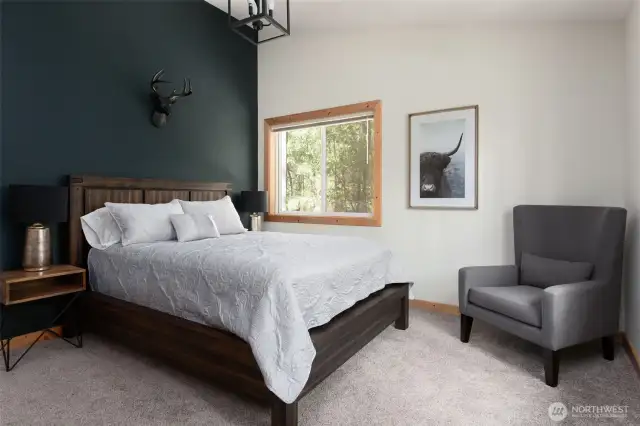 Upstairs bedroom featuring Queen bed with vaulted ceiling and two large windows letting in tons of natural light. (Bedroom #1)