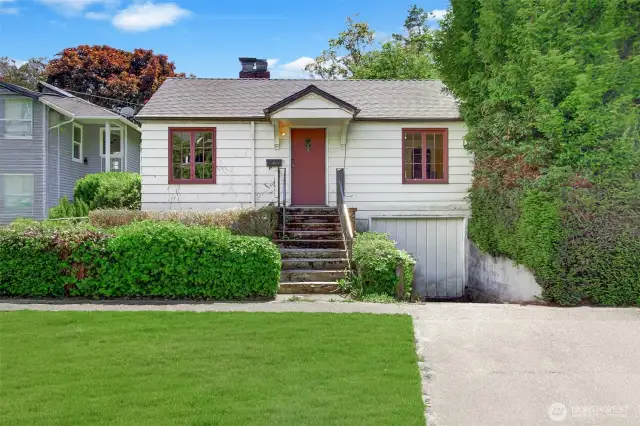 Storybook 1930s Bungalow - Could be restored to its former glory! Many of the original features still in home. NEW ROOF in 2023. Small garage and driveway.
