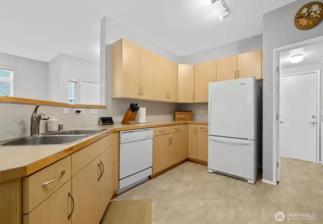 This stylish kitchen shines with sleek cabinetry and full height backsplash.