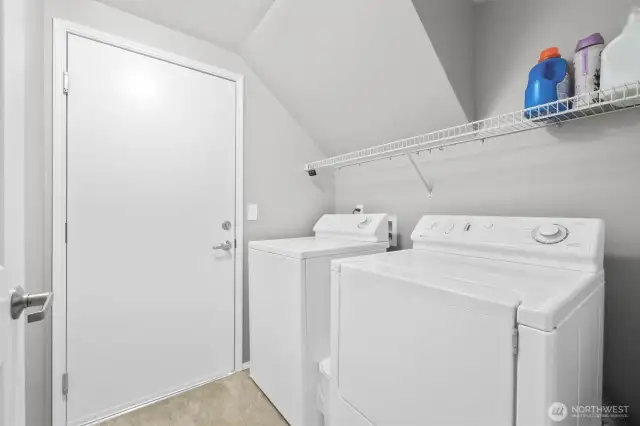 Dedicated laundry room with shelving.