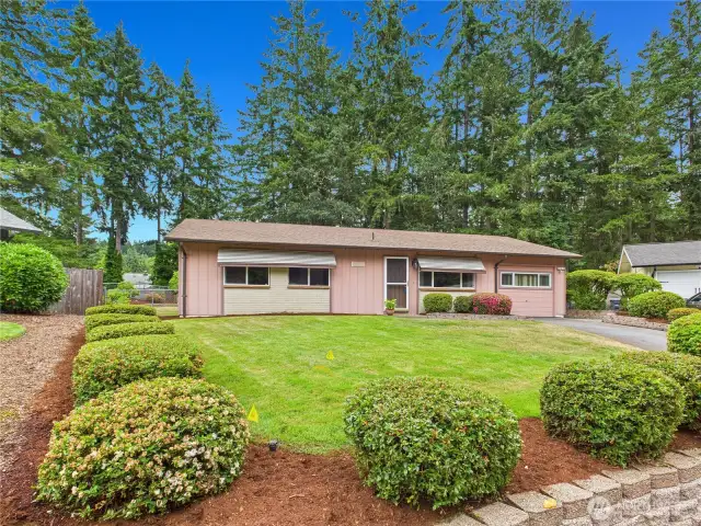 Manicured front yard and fully fenced back yard.