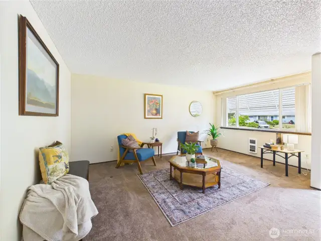 The large window lets in tons of natural light and makes this front room bright.