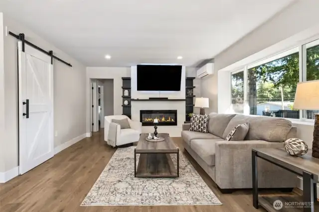LVP flooring, electric fireplace, built-in shelving, mini-split systems for year 'round comfort, updated windows, barn doors, 6" molding - all the contemporary touches you'd want!