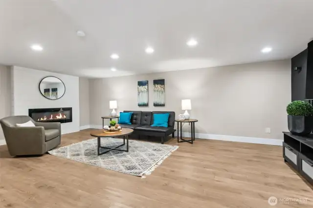 Sizeable basement family room! With electric fireplace PLUS the large TV stays!