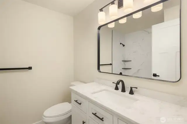Remodeled upstairs bath with new cabinets, counters and shower/bath.