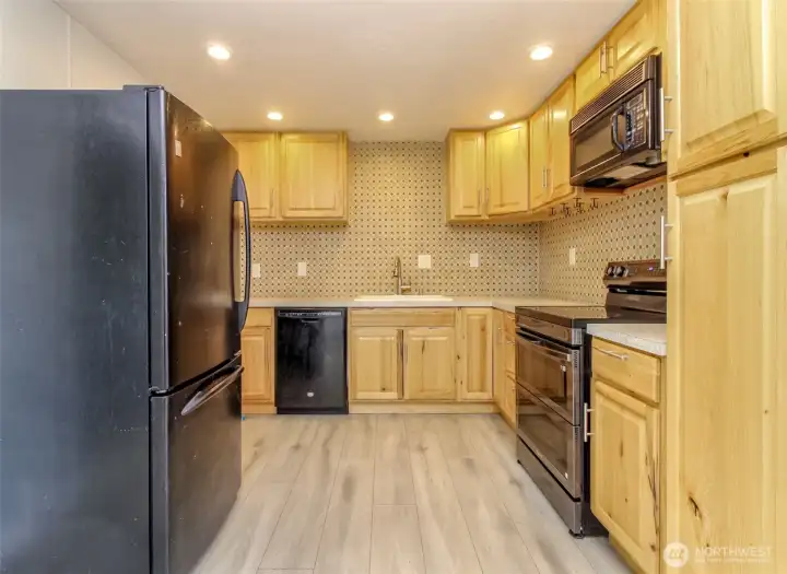 Updated kitchen with nice cupboards, tile texture backsplash and pantry.